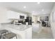 Open kitchen featuring white cabinets, stainless steel appliances, and granite countertops at 2307 Incandescent Way, South Daytona, FL 32119