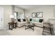 Comfortable living room adjacent to the kitchen area with large windows for natural light at 2307 Incandescent Way, South Daytona, FL 32119