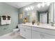 Well-lit bathroom featuring double sinks, a vanity, and modern fixtures at 3311 Grande Heron Dr, St Cloud, FL 34773