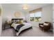 Bright bedroom with large window, decorative pillows, and throw blanket, creating a cozy and relaxing atmosphere at 3311 Grande Heron Dr, St Cloud, FL 34773