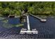 Aerial view of a long private dock, boat dock, and other amenities on a calm body of water at 3311 Grande Heron Dr, St Cloud, FL 34773