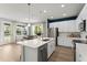 Spacious kitchen with stainless steel appliances, an island, and an adjacent dining area at 3311 Grande Heron Dr, St Cloud, FL 34773