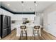 Stylish kitchen featuring a large island with barstool seating and modern lighting at 3311 Grande Heron Dr, St Cloud, FL 34773