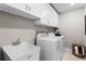 Convenient laundry room with modern washer, dryer, and ample storage cabinets for easy organization at 3311 Grande Heron Dr, St Cloud, FL 34773