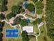 Aerial view of community park featuring walking paths, a playground, volleyball court, and basketball court at 3311 Grande Heron Dr, St Cloud, FL 34773
