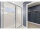 Modern walk-in shower featuring glass doors and white tiled walls at 3311 Grande Heron Dr, St Cloud, FL 34773