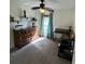 Well-lit bedroom featuring neutral carpeting, a decorative ceiling fan, and desk with dresser at 3651 N Goldenrod E Rd # 102, Winter Park, FL 32792