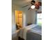 Cozy bedroom featuring a decorative ceiling fan, en-suite bathroom, and a calming color scheme at 3651 N Goldenrod E Rd # 102, Winter Park, FL 32792