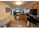 Kitchen featuring granite countertops, stainless steel appliances, and open floor plan at 3651 N Goldenrod E Rd # 102, Winter Park, FL 32792