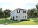 Charming two-story home with gray siding, dark shutters, and a well-manicured lawn at 3737 Isle Royal Pl, Apopka, FL 32712
