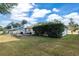 Well-maintained backyard featuring a spacious lawn and a deck, providing ample space for outdoor activities at 4851 Ne 7Th St, Ocala, FL 34470