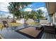 Relaxing backyard deck area featuring outdoor seating, a dark wooden deck, and views of the spacious yard at 4851 Ne 7Th St, Ocala, FL 34470