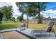 Spacious backyard featuring a deck with lounge chairs, perfect for relaxing and enjoying the outdoors at 4851 Ne 7Th St, Ocala, FL 34470