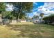 Lush backyard featuring a well-maintained lawn and a deck, perfect for outdoor activities and relaxation at 4851 Ne 7Th St, Ocala, FL 34470
