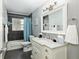 Updated bathroom featuring a marble vanity, modern fixtures, and a shower-tub combo for versatile use at 4851 Ne 7Th St, Ocala, FL 34470