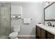 Well-lit bathroom features a glass shower, dark wood vanity, and tiled floors, for a touch of luxury at 4851 Ne 7Th St, Ocala, FL 34470