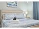 Comfortable bedroom with an ocean-themed painting adding a tranquil touch to the inviting space at 4851 Ne 7Th St, Ocala, FL 34470