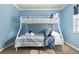 ' bedroom with a bunk bed featuring soft, striped bedding and a cozy atmosphere at 4851 Ne 7Th St, Ocala, FL 34470