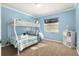 Cozy ' bedroom features a bunk bed with striped bedding and a bright blue accent wall at 4851 Ne 7Th St, Ocala, FL 34470