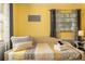 Well-lit bedroom showcasing a stylish daybed with accent pillows and a view from the window at 4851 Ne 7Th St, Ocala, FL 34470