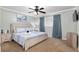 Comfortable bedroom featuring a ceiling fan, carpet floors, and soothing blue accents for a relaxing ambiance at 4851 Ne 7Th St, Ocala, FL 34470