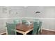 Dining room boasting a wooden table, mint-colored chairs, and gray walls with white trim at 4851 Ne 7Th St, Ocala, FL 34470