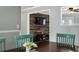 Close-up of a dining room table with mint-colored chairs and view into the den at 4851 Ne 7Th St, Ocala, FL 34470
