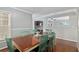 Open dining room showcasing a table with mint chairs and an open view to the den at 4851 Ne 7Th St, Ocala, FL 34470