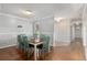Dining room with wood floors, wainscotting, and a view of a wallpapered hallway at 4851 Ne 7Th St, Ocala, FL 34470