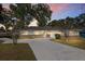Charming one-story home with a well-maintained lawn, a long driveway, and a two-car garage at 4851 Ne 7Th St, Ocala, FL 34470