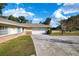 Charming one-story home with a well-maintained lawn, a long driveway, and a two-car garage at 4851 Ne 7Th St, Ocala, FL 34470