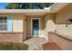 Inviting front entrance featuring a decorative glass door, brick accents, and a cozy covered porch at 4851 Ne 7Th St, Ocala, FL 34470