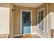 Inviting front entrance featuring a decorative glass door, brick accents, and a cozy covered porch at 4851 Ne 7Th St, Ocala, FL 34470
