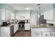 Charming kitchen with white cabinets, stainless appliances, granite counters, and breakfast bar at 4851 Ne 7Th St, Ocala, FL 34470