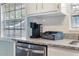 Granite counters and stainless dishwasher are features of this bright kitchen at 4851 Ne 7Th St, Ocala, FL 34470