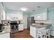 Charming kitchen with white cabinets, stainless appliances, granite counters, and breakfast bar at 4851 Ne 7Th St, Ocala, FL 34470