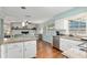Open concept living space with granite island and view to the living room at 4851 Ne 7Th St, Ocala, FL 34470