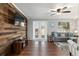 Bright living room with hardwood floors, wood accent wall, and stylish furniture at 4851 Ne 7Th St, Ocala, FL 34470