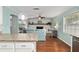 Open concept living space with granite island and view to the living room at 4851 Ne 7Th St, Ocala, FL 34470