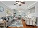 Bright living room showcasing hardwood floors, comfortable furniture, and an open floor plan at 4851 Ne 7Th St, Ocala, FL 34470