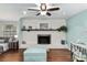 Living room with whitewashed brick fireplace, wooden mantel, and view of blue office nook at 4851 Ne 7Th St, Ocala, FL 34470