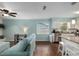 View of living room, office nook, and kitchen with a bar and white cabinets at 4851 Ne 7Th St, Ocala, FL 34470