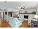 Open living space with fireplace, wood floors, and view of a den and an office nook at 4851 Ne 7Th St, Ocala, FL 34470