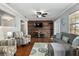 Inviting living room with a wood accent wall, hardwood floors, and comfortable seating at 4851 Ne 7Th St, Ocala, FL 34470