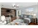 Charming living room with wood floors, a stylish gray sofa, and a TV at 4851 Ne 7Th St, Ocala, FL 34470