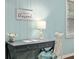 Close up of desk in office nook with light blue walls, window, and decorative wall sign at 4851 Ne 7Th St, Ocala, FL 34470