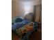 Comfortable bedroom featuring marine bedding, a dresser, and soft lighting at 11301 Huggins St, Leesburg, FL 34788