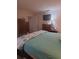 Bedroom with a large bed, dressers, a wall-mounted TV, and neutral paint at 11301 Huggins St, Leesburg, FL 34788