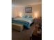 Bedroom features coastal bedding, wood furniture, and a nautical-themed decorative pillow at 11301 Huggins St, Leesburg, FL 34788