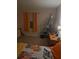 Bedroom with a bed, adjacent window, storage shelf, and dresser at 11301 Huggins St, Leesburg, FL 34788